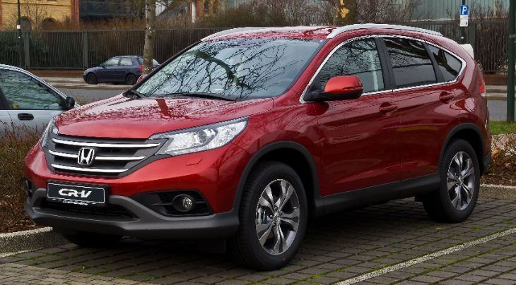 A pre-owned 4th generation Honda CR-V in a suburban neighborhood